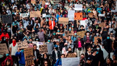 Hundreds of protesters holding Black Lives Matter signs