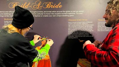 Visitors at the Build a Bride exhibit at Westport Museum