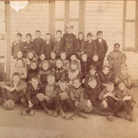 19th century school class photograph where one girl--Anna Simms--an African American student is standing alone.